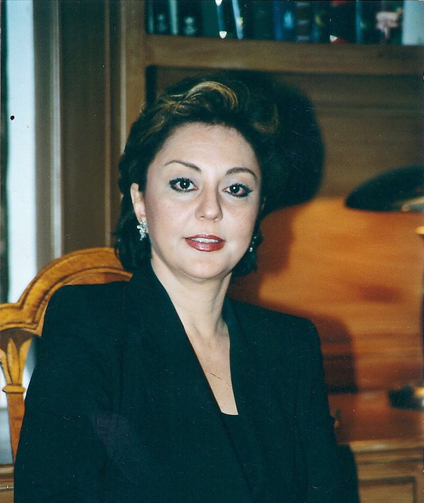 Attorney Roya Rohani seated in front of law books